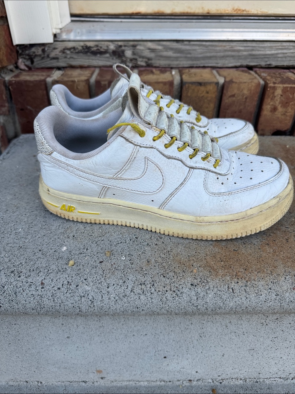 White womens Air Force 1 Leather Sneakers with Yellow Accents Size 6.5 Preloved